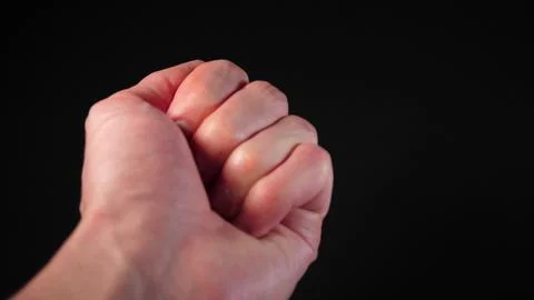 The man stretches out and opens his hand with a 4k coin. Donation assistance. Stock Photos