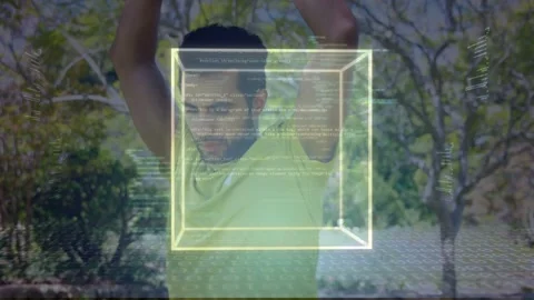 Man stretching arms in park and initiating AR tech demo, wireframe cube and code Stock Footage 333609965