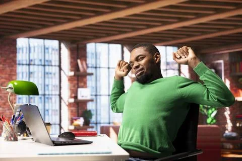 Man stretching back to relieve backache pain gained from incorrect posture Stock Photos