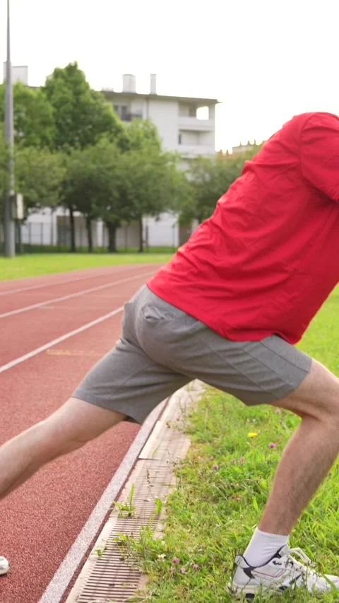 Man stretching back in a running track Stock Footage 299896663