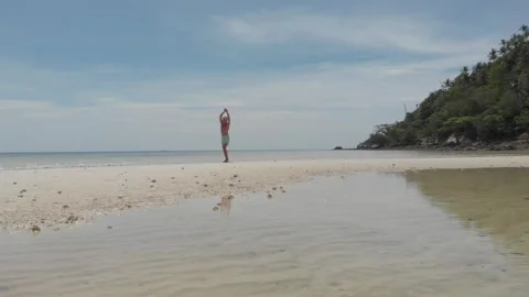 Man stretching on the beach Stock Footage 260431172
