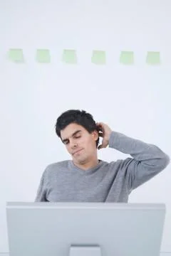 Man stretching at computer 写真素材
