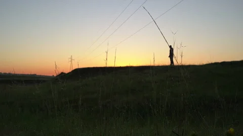 Man stretching on a hill at dawn Stock Footage 132453352