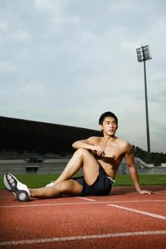Man stretching on track Stock Photos