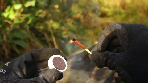 Man Strikes a Match. Man strikes a match for making Campfires. Stock Footage 306517286