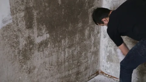 Man strikes the primer on the plaster wall Stock Footage 83873117