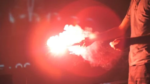 Man Striking Red Road Flare in Slow Motion Stock Footage 81108203