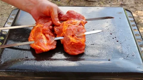 A man stringing juicy meat on a skewer for grilling kebabs Stock Footage 158987039