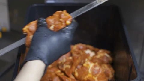A man is stringing meat on a skewer.Delicious appetizing pieces of fresh meat Stock Footage 99724509