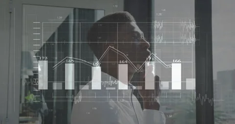Man stroking beard and studying finance charts expanding in front of city Stock Footage 311506442
