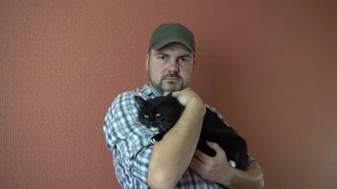 Man stroking a cat in his hands 4K Stock Footage 87801647