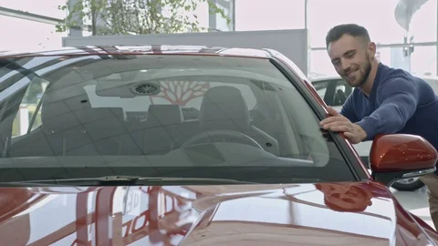 Man stroking his hand carefully on car near windshield. Stock Footage 99773176