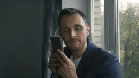 A man stroking a notebook with a satisfied expression on his face Stock Footage 156048364