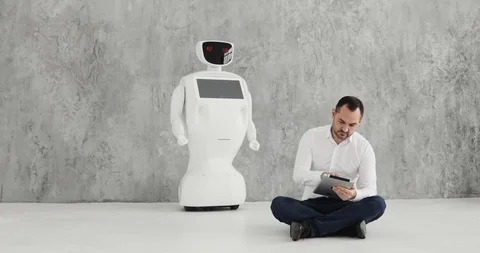 Man stroking a robot. friendship with a robot. Modern Robotic Technologies. A Stock Footage 97967679