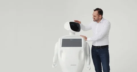 Man stroking a robot. friendship with a robot. Modern Robotic Technologies. A Stock Footage 97967686