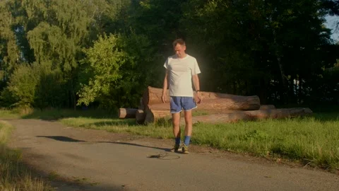 A man strolls through nature, capturing serene greenery and tranquility Stock Footage 314346396