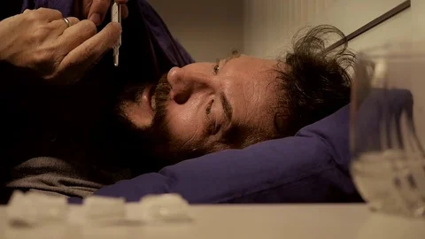 Man with strong fever in bed at sunset screaming looking camera slow motion Stock Footage 78647020