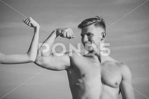 Man with strong hand biceps, triceps smile at female hand Stock Photos
