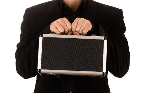 Man strong keeps in a black jacket and a black shirt before himself a metal c Stock Photos
