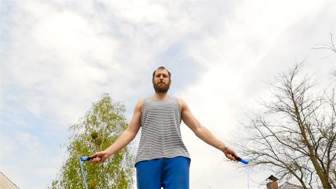 A man of strong physique jumps on a rope Stock Footage 88908820