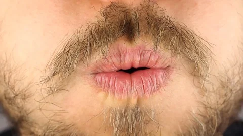 Man strongly blows on camera, puffs cheeks, blows candle, front view, closeup Video stock 102889956