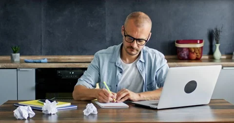 Man struggles with writing plan and analysing information Stock Footage 228567233