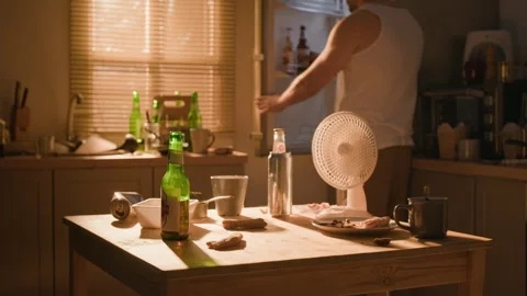 Man Struggling with Alcohol Addiction Drinking at Kitchen Table Stock Footage 344873809