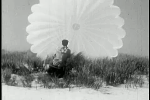 Man struggling with an open parachute Stock Footage 11356161
