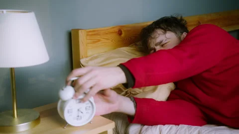 Man Struggling to Wake Up  Hitting Snooze on Alarm Clock Stock Footage 303917627
