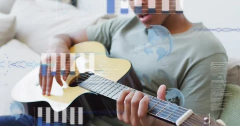 Man strumming guitar on sofa, activating bar charts, globe icon and code lines Stock Footage 326096175