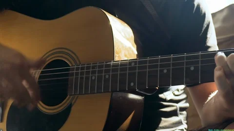 Man strums and plays the guitar Video stock 121546972