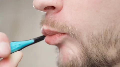 Man with stubble brushing his teeth close-up Stock-Footage 198868111
