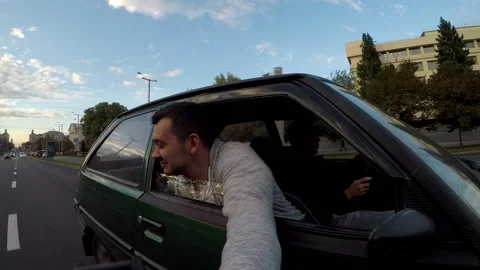 A man stuck his head out the window and shoots himself against the flow of wind Stock Footage 160926269