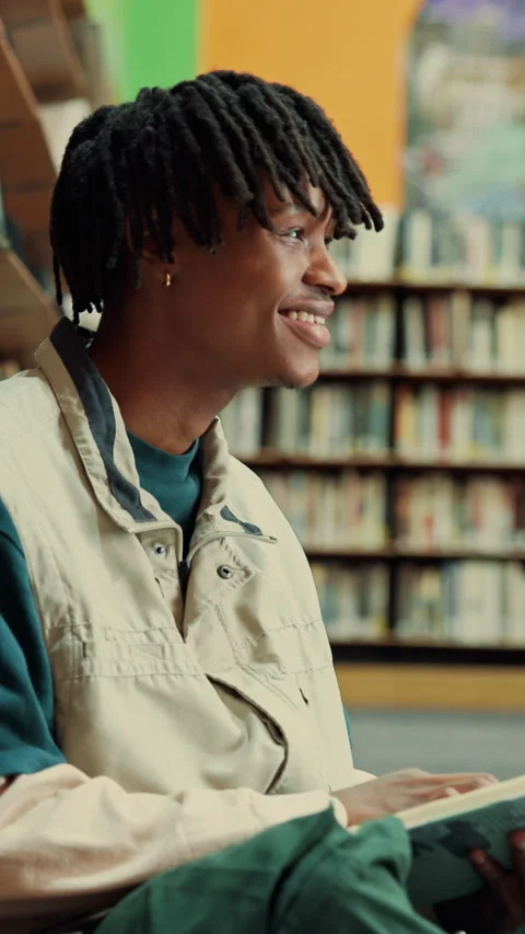 Man, student and reading in library with books for learning, education or study Stock Footage 335812599