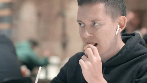 Man student eats nuggets, french fries and drinks cola at McDonalds fast food Stock Footage 159787940