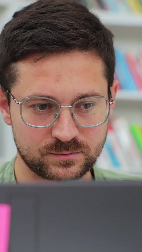 Man student preparing exam and learning lessons in library Stock Footage 345145988