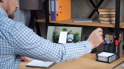 Man student study at home office online video call laptop, writes in notebook Stock Footage 153110844