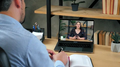 Man student study online video call laptop, writes in notebook listen teacher Video stock 146227033