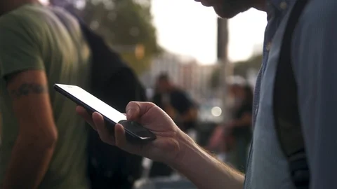 Man student using a smart phone voice recognition function online walking on a Video stock 120022349