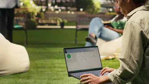 Man student working with solar panels data for sustainable energy on laptop Stock Footage 340961545