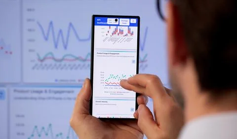 Man Studies Financial Data And Trends On Computer Dashboard In Modern Office. Stock-Fotos