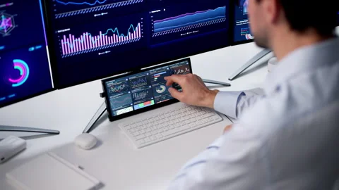 Man Studies Financial Data On Computer Monitor Stock Footage 334930262