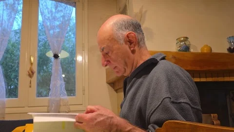 Man studies a note on papers at home 스톡 동영상 328318229