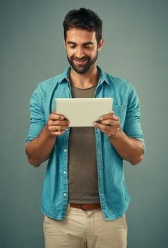 Man, studio and checking with tablet and smile, career with software programming Foto stock