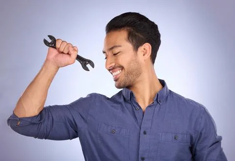 Man, studio and happy with tools or spanner for handyman, maintenance or repair Stock Photos