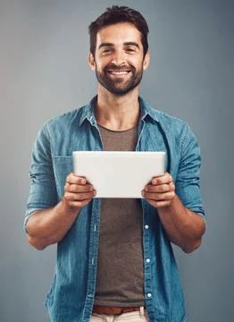 Man, studio and portrait with tablet and smile, career with software programming Stock Photos