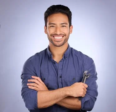 Man, studio and portrait with tools or spanner for handyman, maintenance or Stock Photos