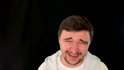 Man on studio black background laughing and unable to stop, hilarious reaction 스톡 동영상 192059908