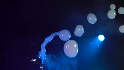 Man in the Studio blows soap bubbles Stock Footage 141707885