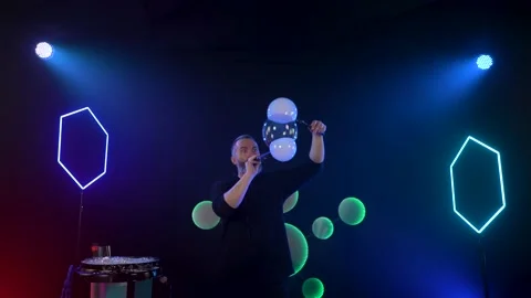 Man in the Studio blows soap bubbles Stock Footage 141708303
